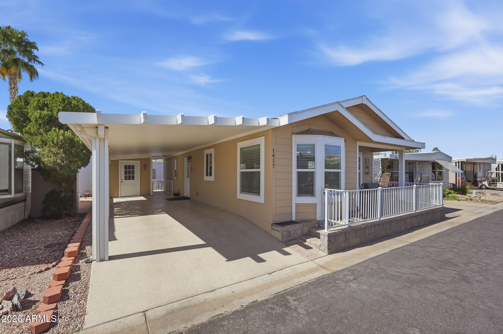 8865 East Baseline Road, Unit 1417 Mesa, AZ 85209 - Photo 29 of 47 a front view of a house with a porch