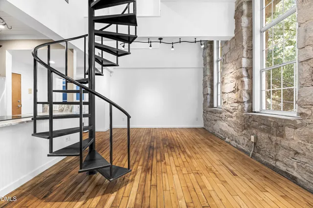 a view of entryway with wooden floor and stairs