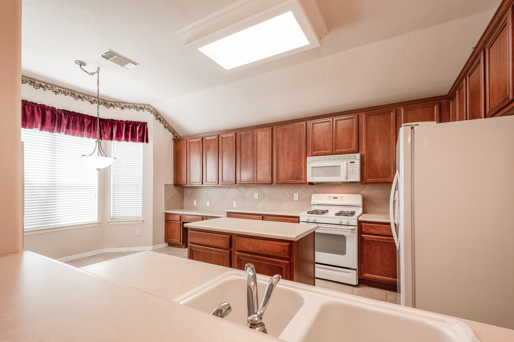5914 Birdie Way Pasadena, TX 77505 - Photo 11 of 32 a kitchen with stainless steel appliances granite countertop a refrigerator sink and cabinets