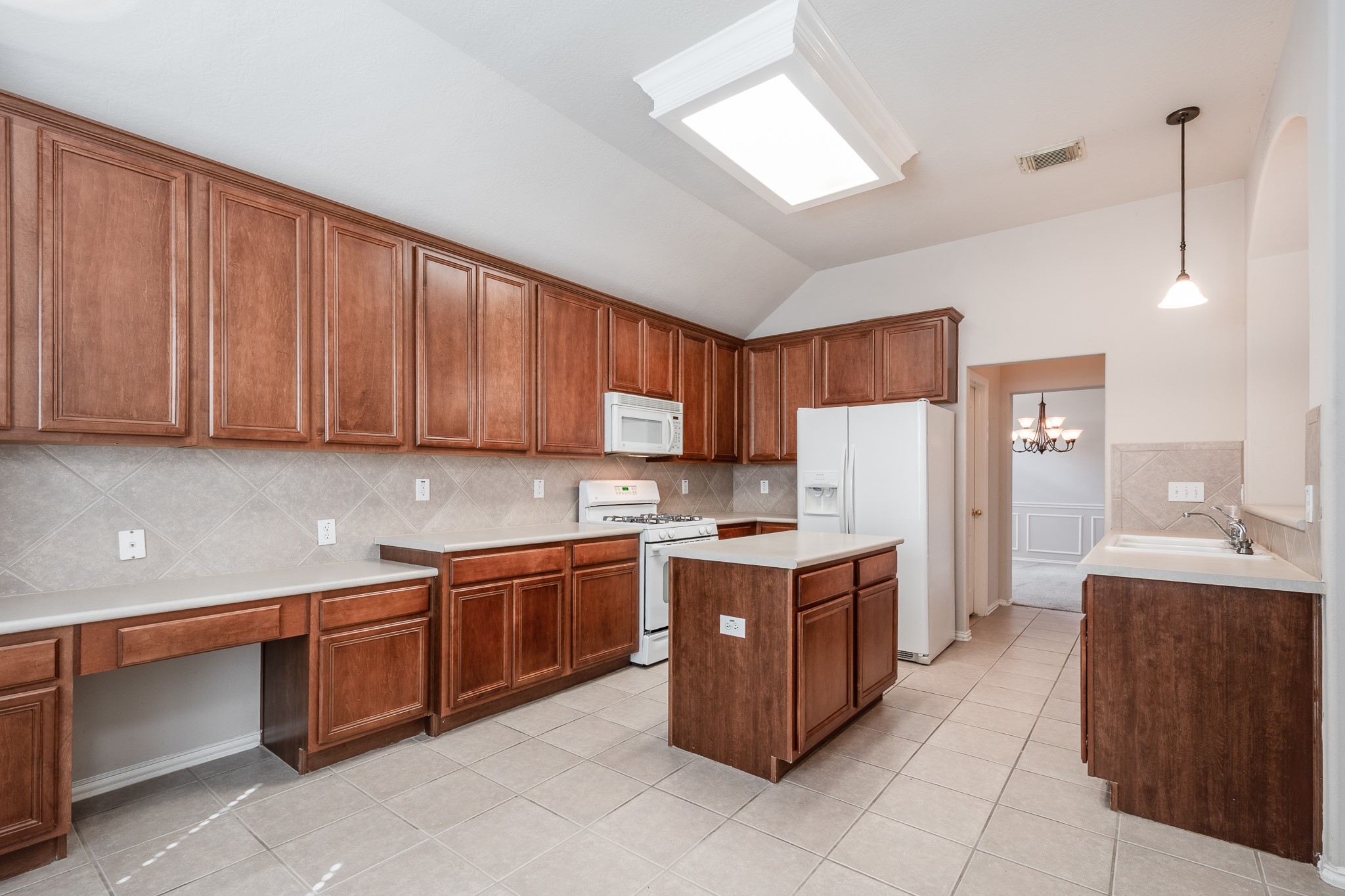 5914 Birdie Way Pasadena, TX 77505 - Photo 14 of 32 a kitchen with stainless steel appliances a sink a stove a refrigerator cabinets and a window