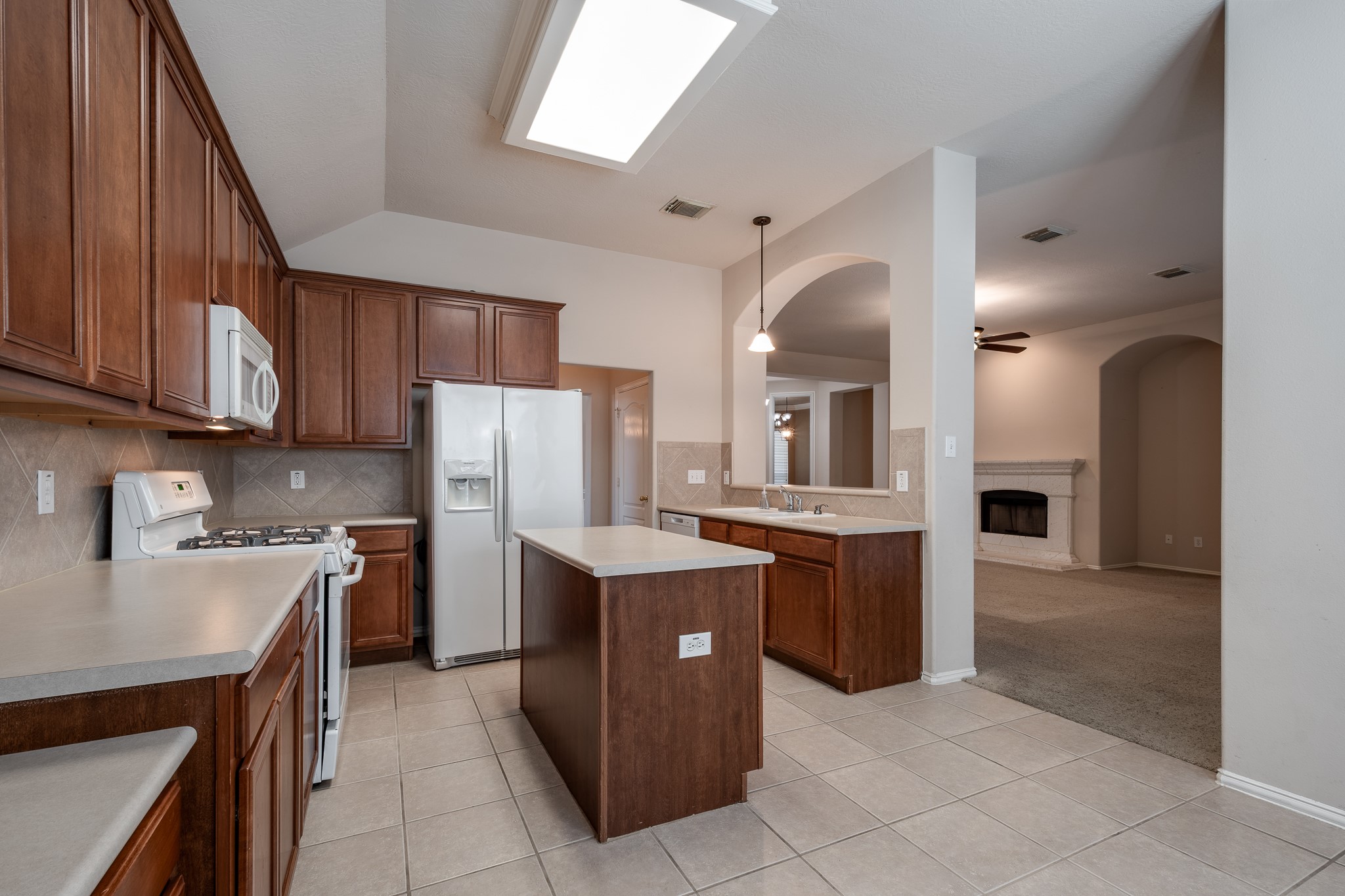 5914 Birdie Way Pasadena, TX 77505 - Photo 15 of 32 a kitchen with a sink a stove top oven and cabinets