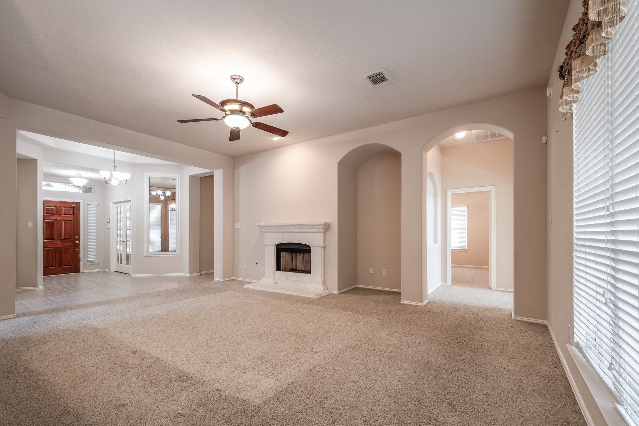 5914 Birdie Way Pasadena, TX 77505 - Photo 9 of 32 a view of a livingroom with a fireplace and a chandelier fan