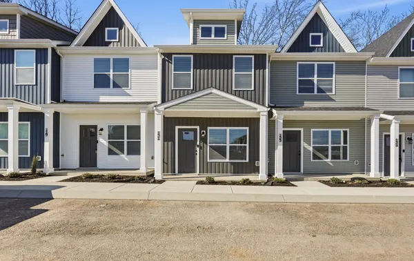 a front view of a house with a yard