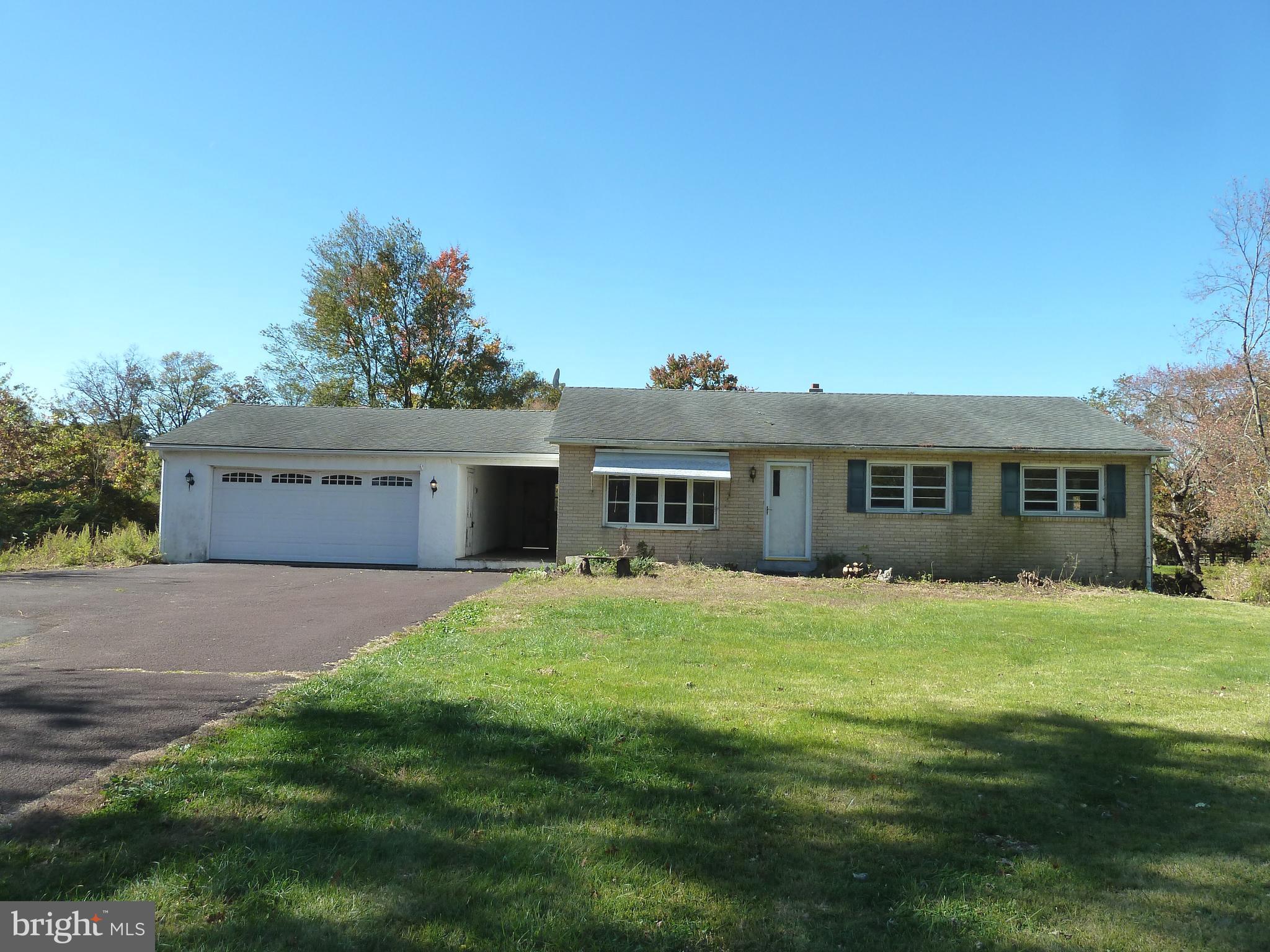 a front view of a house with yard and green space