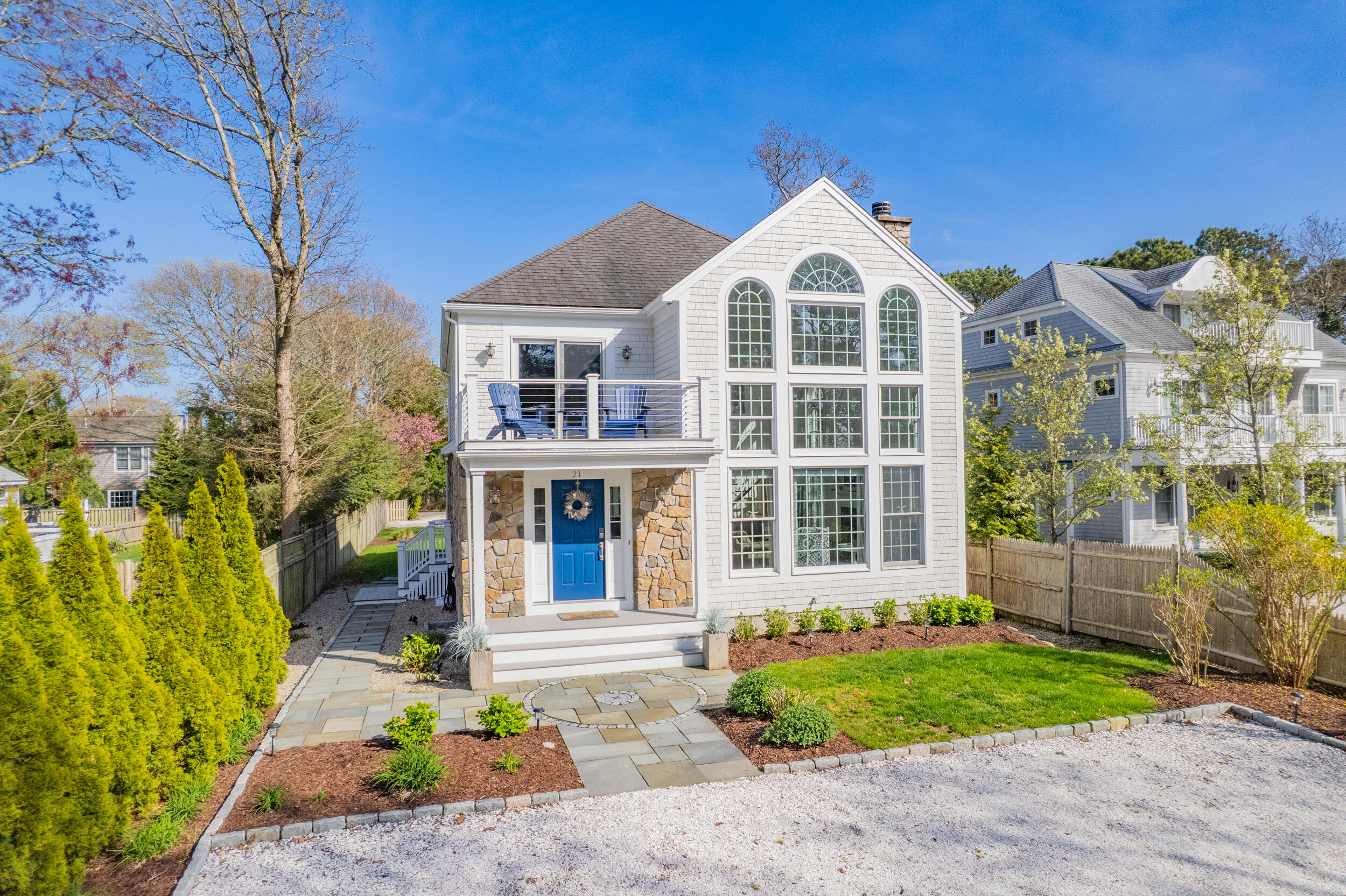 21 Bayview Road Mashpee, MA 02649 - Photo 72 of 85 a front view of a house with a garden and plants