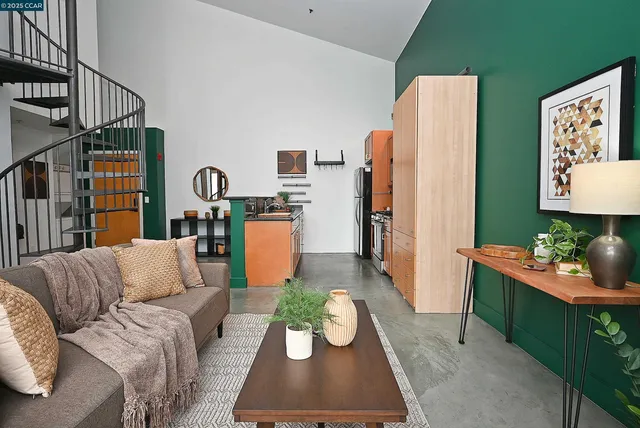 a living room with furniture kitchen view and a window