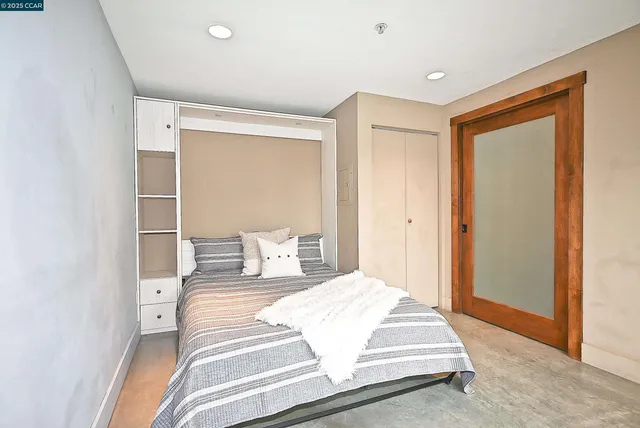 a bedroom with a bed and a dresser