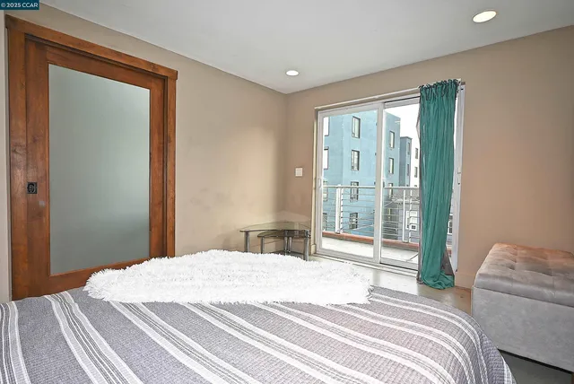 a bedroom with a bed and a large window