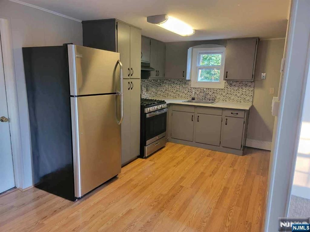 295 Lincoln Avenue Ridgewood, NJ 07450 - Photo 3 of 17 a kitchen with a refrigerator and a sink