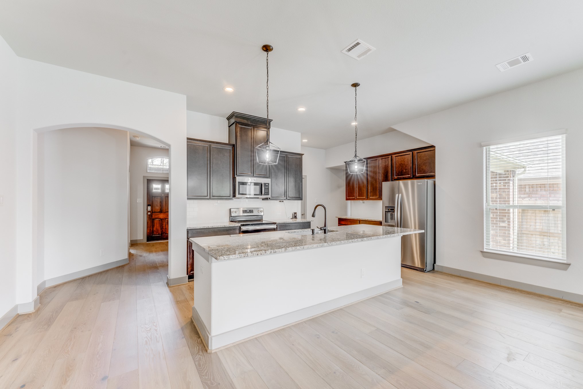11913 Mockingbird Lane Montgomery, TX 77356 - Photo 11 of 19 a view of a kitchen with stainless steel appliances granite countertop a sink a refrigerator and a stove