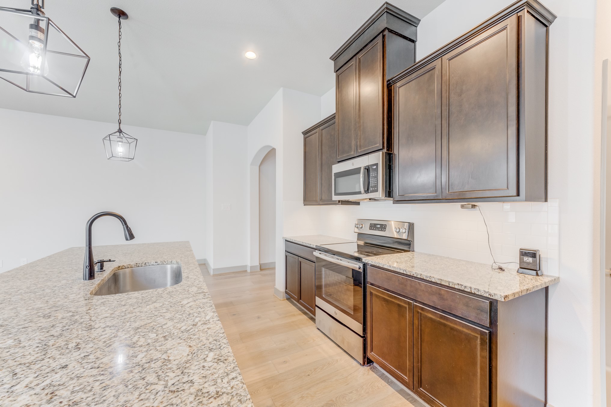 11913 Mockingbird Lane Montgomery, TX 77356 - Photo 13 of 19 a kitchen with stainless steel appliances granite countertop a sink a stove and a refrigerator