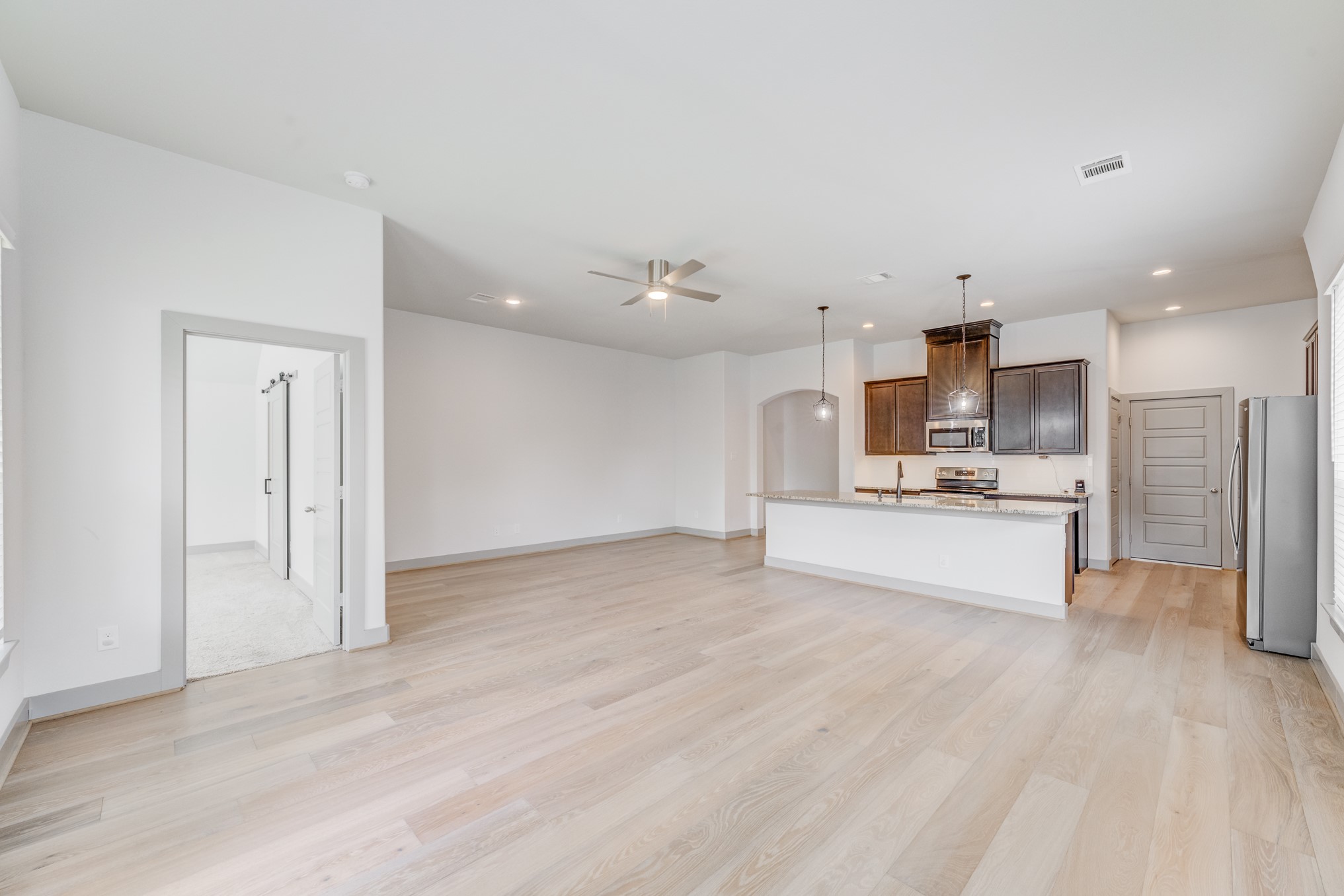 11913 Mockingbird Lane Montgomery, TX 77356 - Photo 14 of 19 a view of kitchen with kitchen island a sink wooden floor and stainless steel appliances