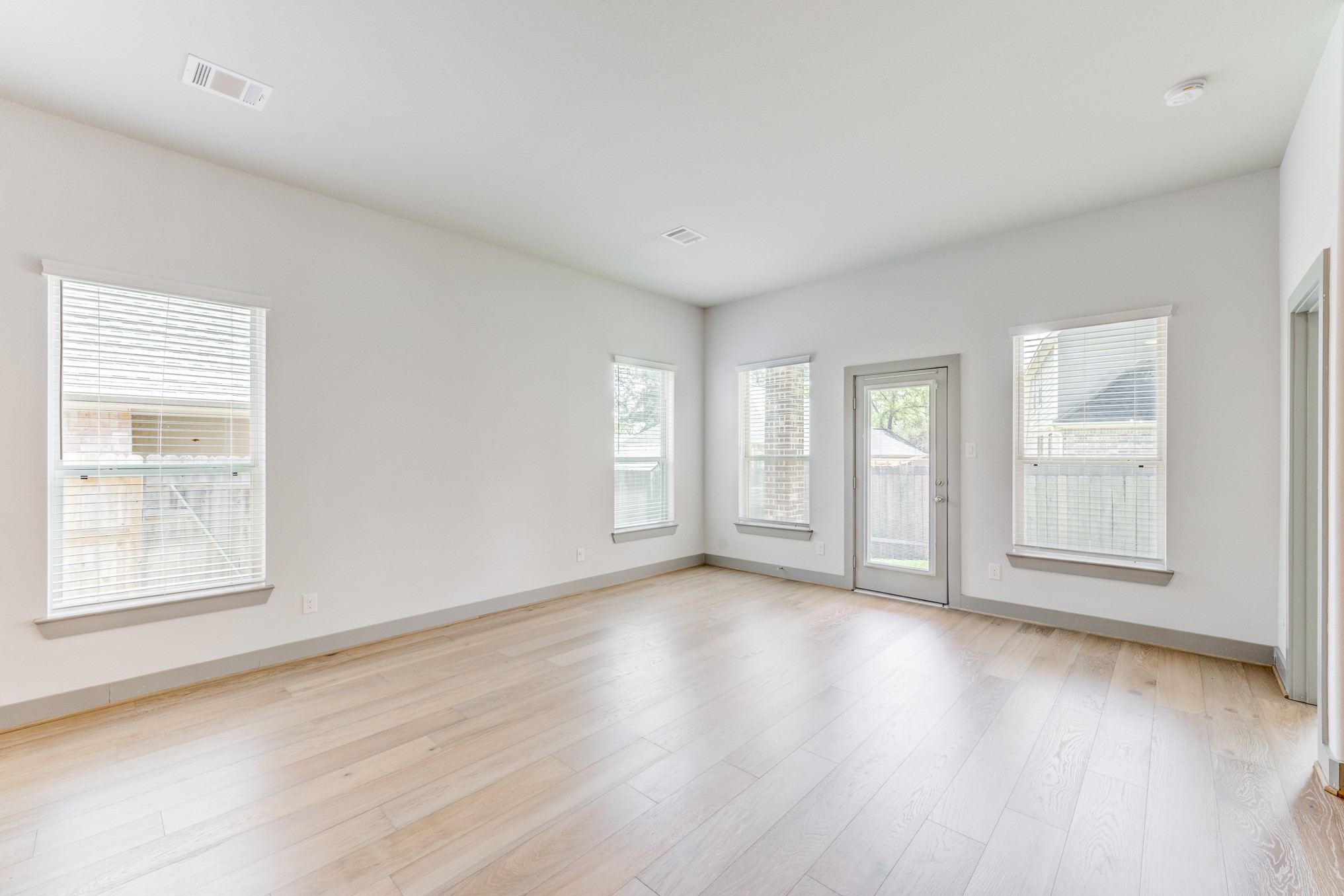 11913 Mockingbird Lane Montgomery, TX 77356 - Photo 17 of 19 an empty room with wooden floor and windows
