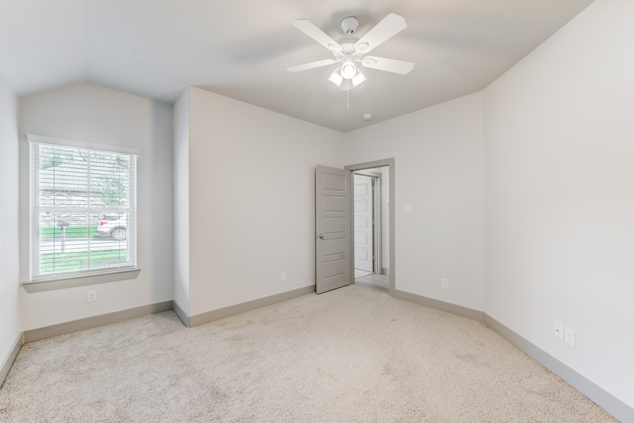 11913 Mockingbird Lane Montgomery, TX 77356 - Photo 9 of 19 an empty room with chandelier fan and windows