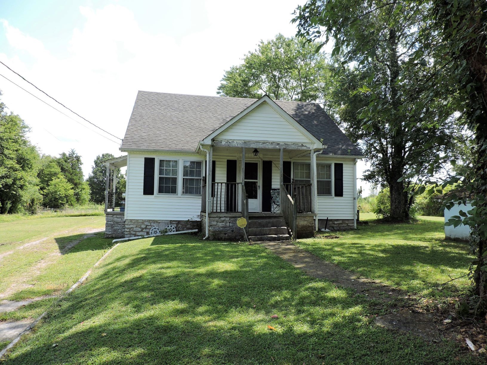 a view of a house with a yard and sitting area