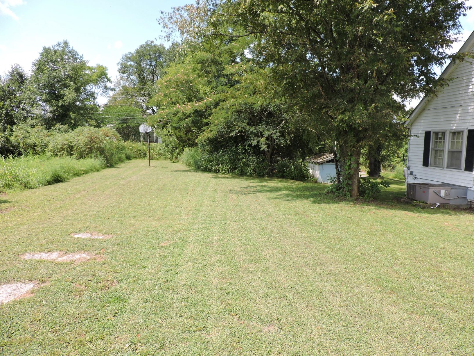 10891 Murfreesboro Road Lebanon, TN 37090 - Photo 8 of 16 a backyard of a house with yard and trampoline