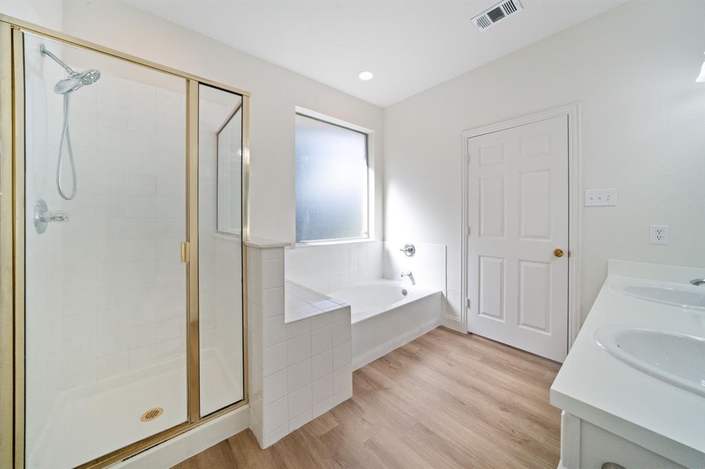 908 West Wintergreen Road Lancaster, TX 75134 - Photo 20 of 38 a view of empty room with wooden floor and fan