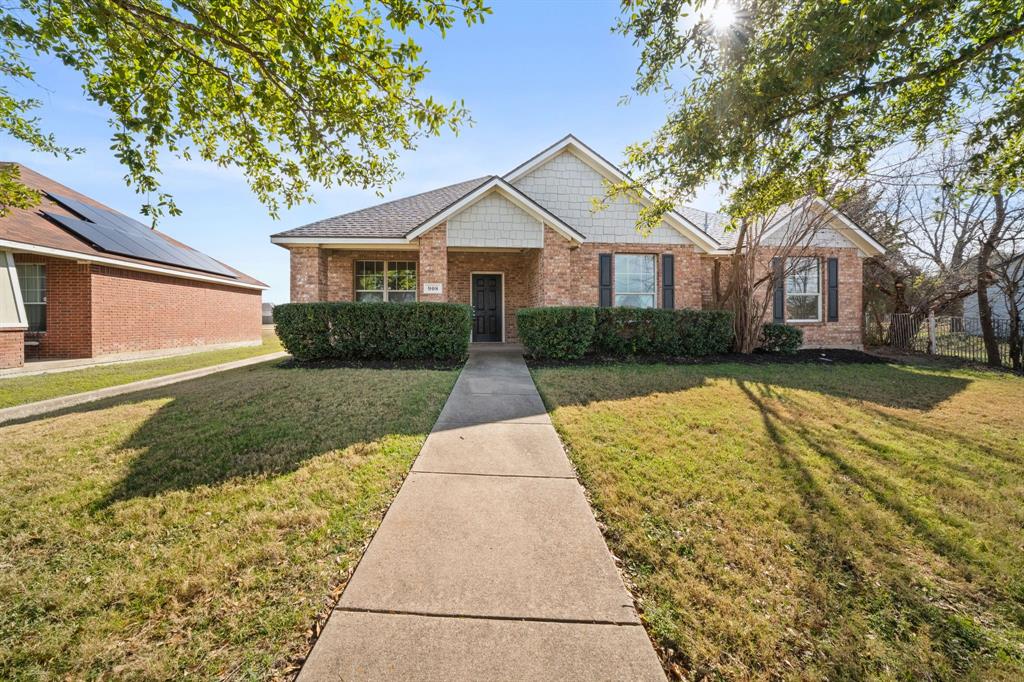 908 West Wintergreen Road Lancaster, TX 75134 - Photo 29 of 38 a front view of a house with a yard and garage
