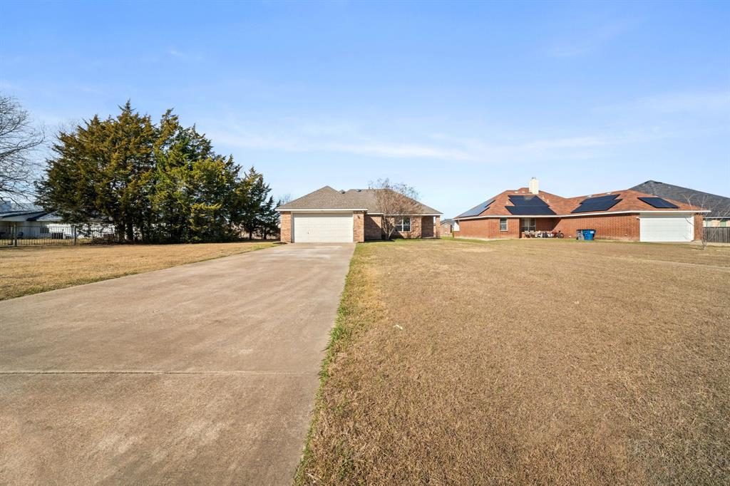 908 West Wintergreen Road Lancaster, TX 75134 - Photo 36 of 38 a view of a house with a yard and mountain view