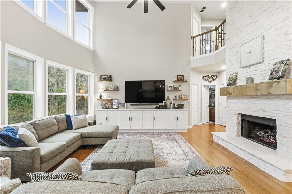 1122 Flagstone Way Acworth, GA 30101 - Photo 12 of 50 a living room with furniture a flat screen tv and a fireplace