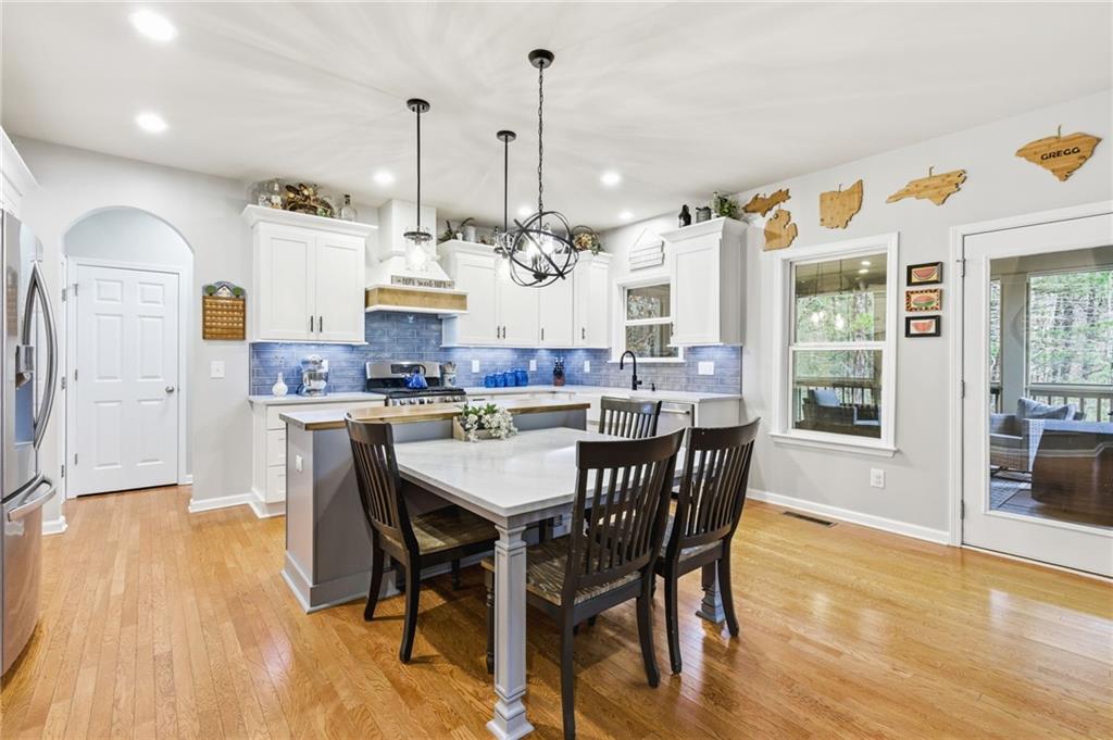 1122 Flagstone Way Acworth, GA 30101 - Photo 16 of 50 a view of a dining room and livingroom with furniture wooden floor a chandelier