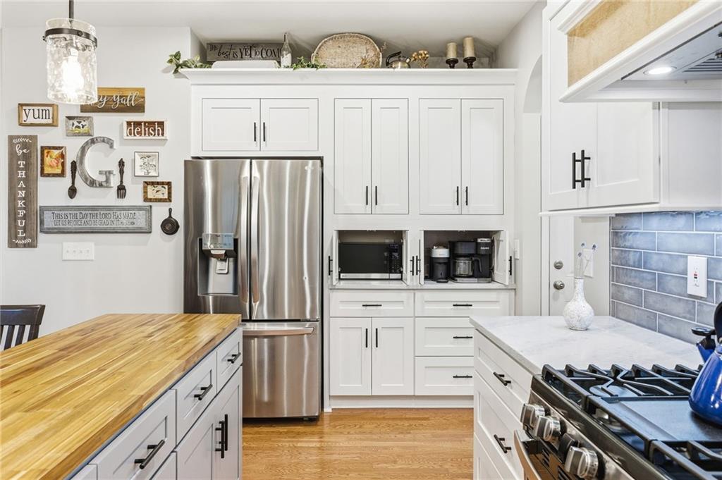 1122 Flagstone Way Acworth, GA 30101 - Photo 20 of 50 a kitchen with stainless steel appliances a stove and a refrigerator
