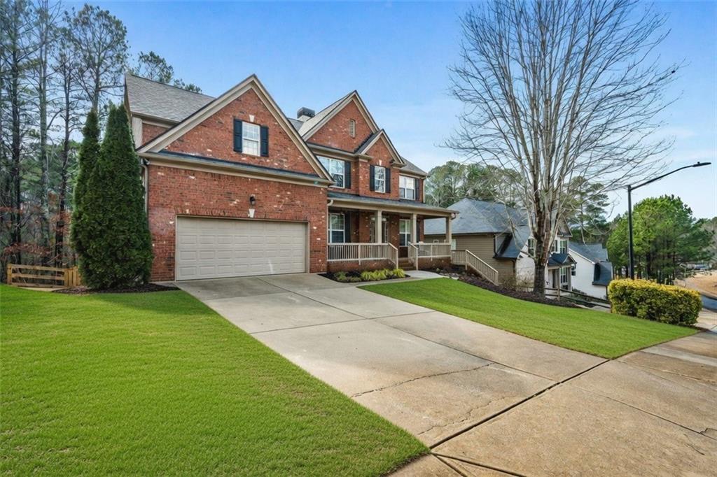 1122 Flagstone Way Acworth, GA 30101 - Photo 2 of 50 a front view of a house with a yard and garage