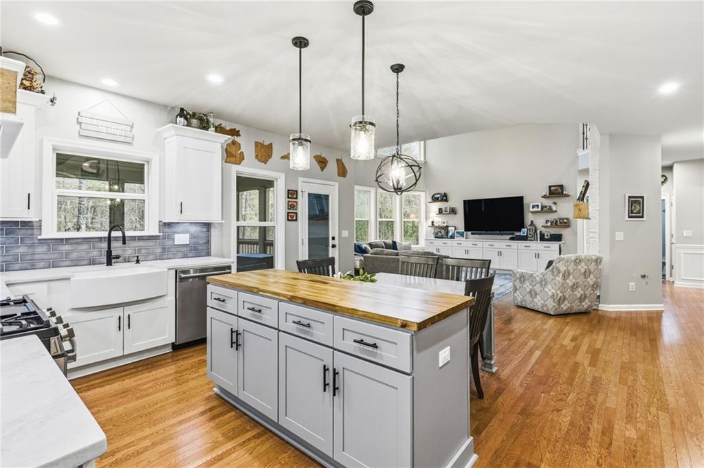 1122 Flagstone Way Acworth, GA 30101 - Photo 21 of 50 a large kitchen with kitchen island granite countertop a sink and a wooden floor