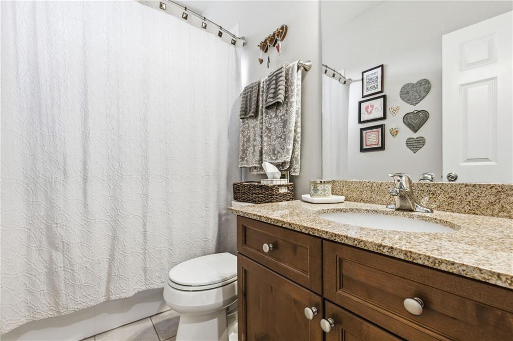 1122 Flagstone Way Acworth, GA 30101 - Photo 23 of 50 a bathroom with a granite countertop sink toilet and shower