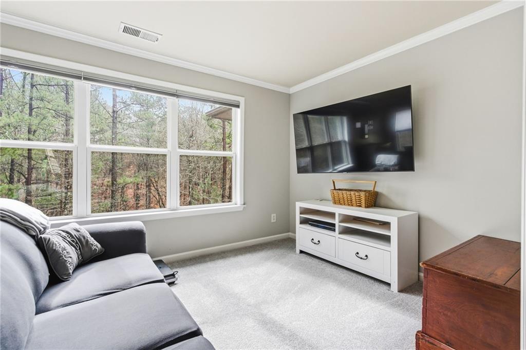 1122 Flagstone Way Acworth, GA 30101 - Photo 25 of 49 a living room with furniture and a flat screen tv