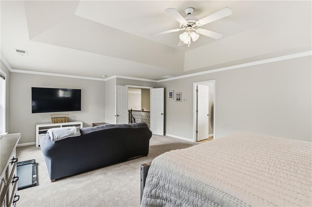 1122 Flagstone Way Acworth, GA 30101 - Photo 27 of 50 a bedroom with a bed and a flat screen tv