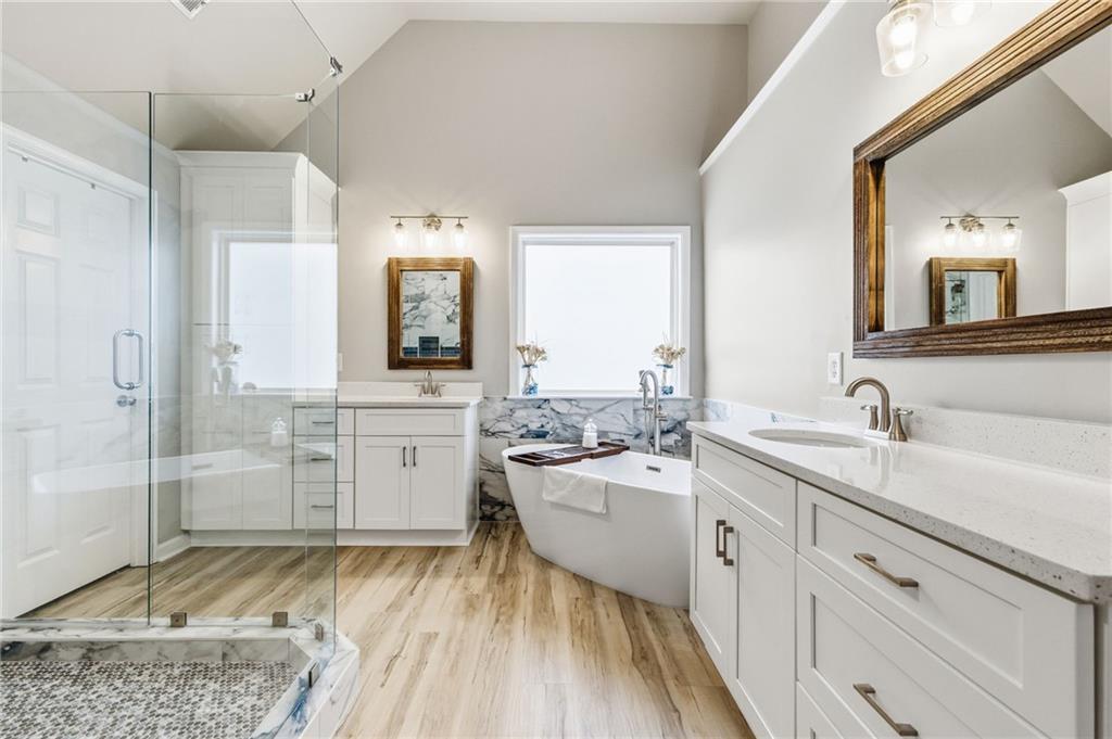1122 Flagstone Way Acworth, GA 30101 - Photo 28 of 50 a view of a bathroom with a sink mirror and a bathtub