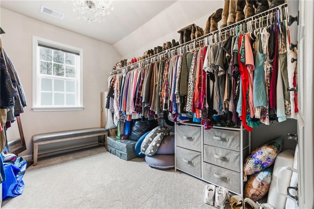 1122 Flagstone Way Acworth, GA 30101 - Photo 32 of 49 a view of walk in closet with clothes