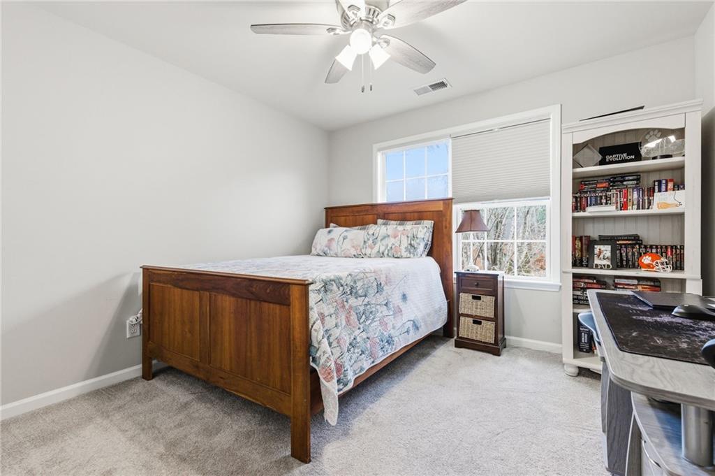 1122 Flagstone Way Acworth, GA 30101 - Photo 34 of 50 a bedroom with a bed and a chandelier