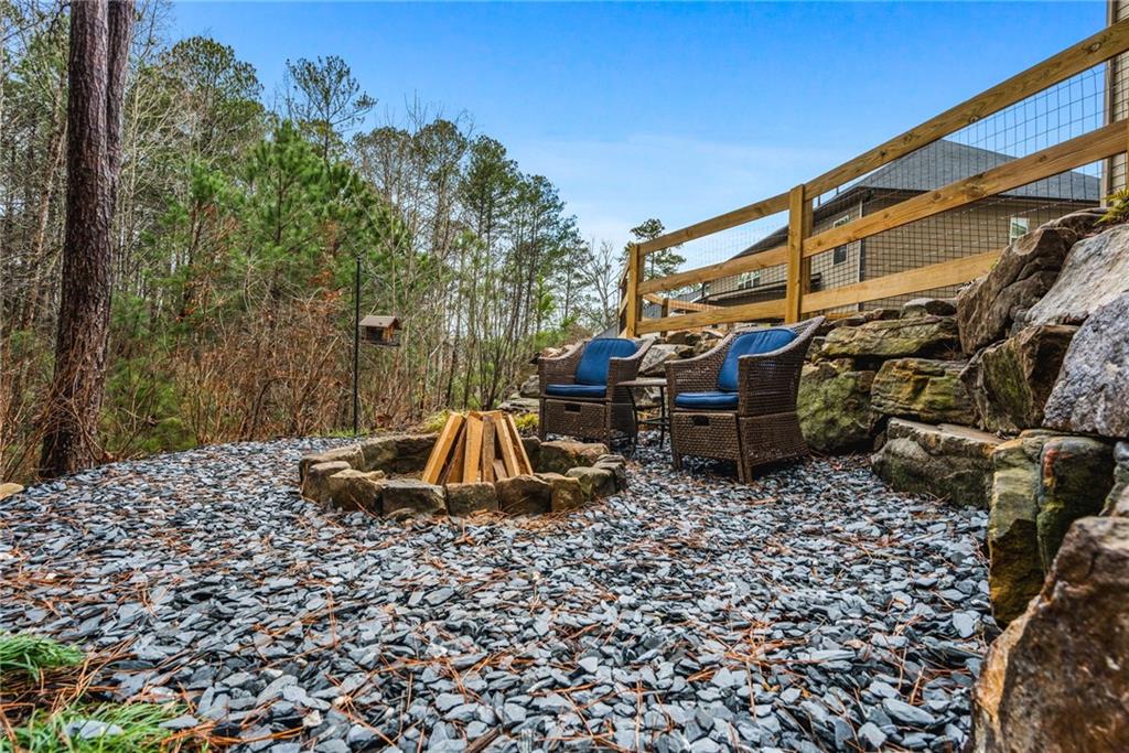 1122 Flagstone Way Acworth, GA 30101 - Photo 46 of 49 a backyard of a house with barbeque oven and a fountain