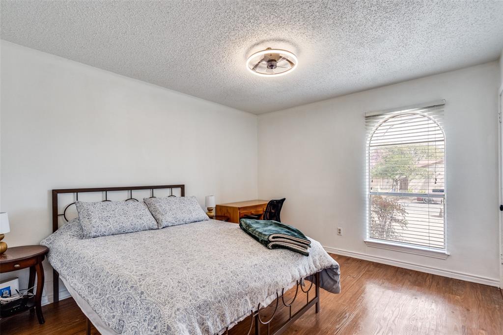 15642 Overmead Circle Dallas, TX 75248 - Photo 20 of 24 a bedroom with a bed and wooden floor