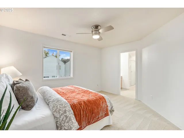 a bedroom with a large bed and a window