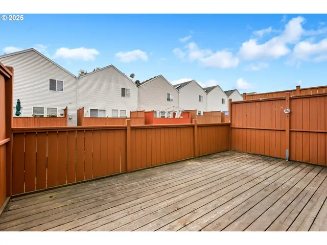 a view of a house with wooden deck