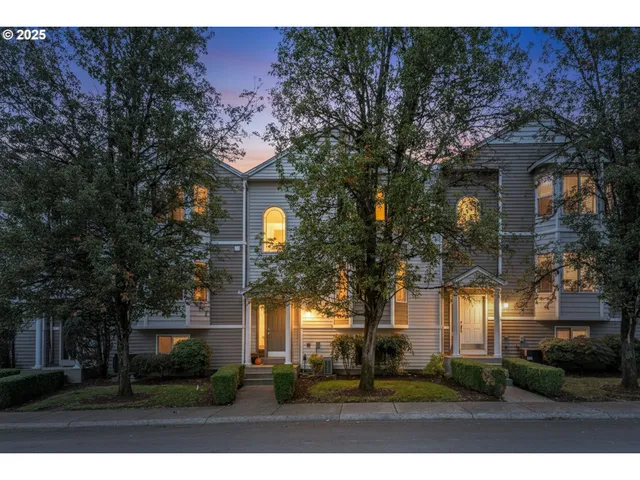 a view of a house with a patio and a yard