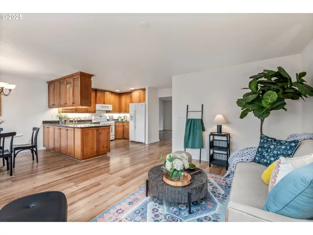 a living room with furniture and a kitchen area