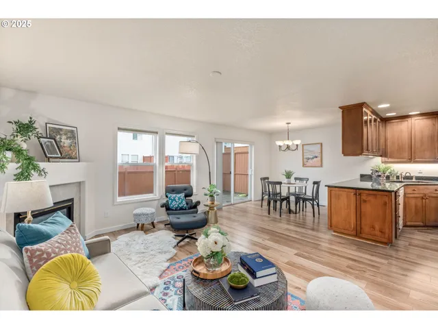 a living room with furniture a fireplace and kitchen view