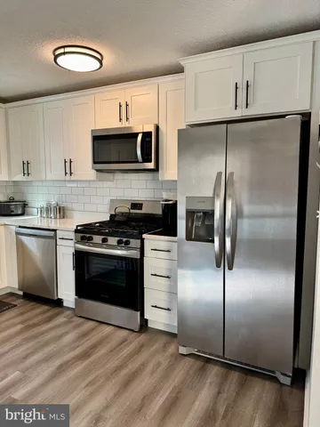 a kitchen with a refrigerator a sink and a stove