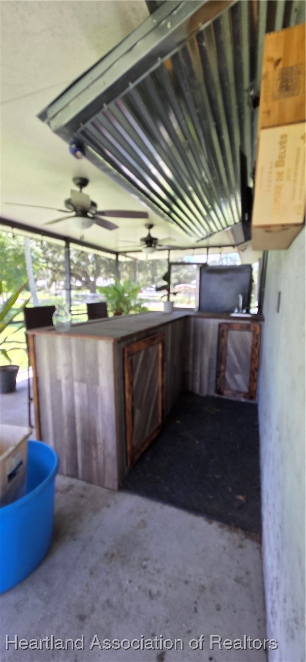 307 Southwest 10th Street Okeechobee, FL 34974 - Photo 31 of 38 screen porch with bar and TV