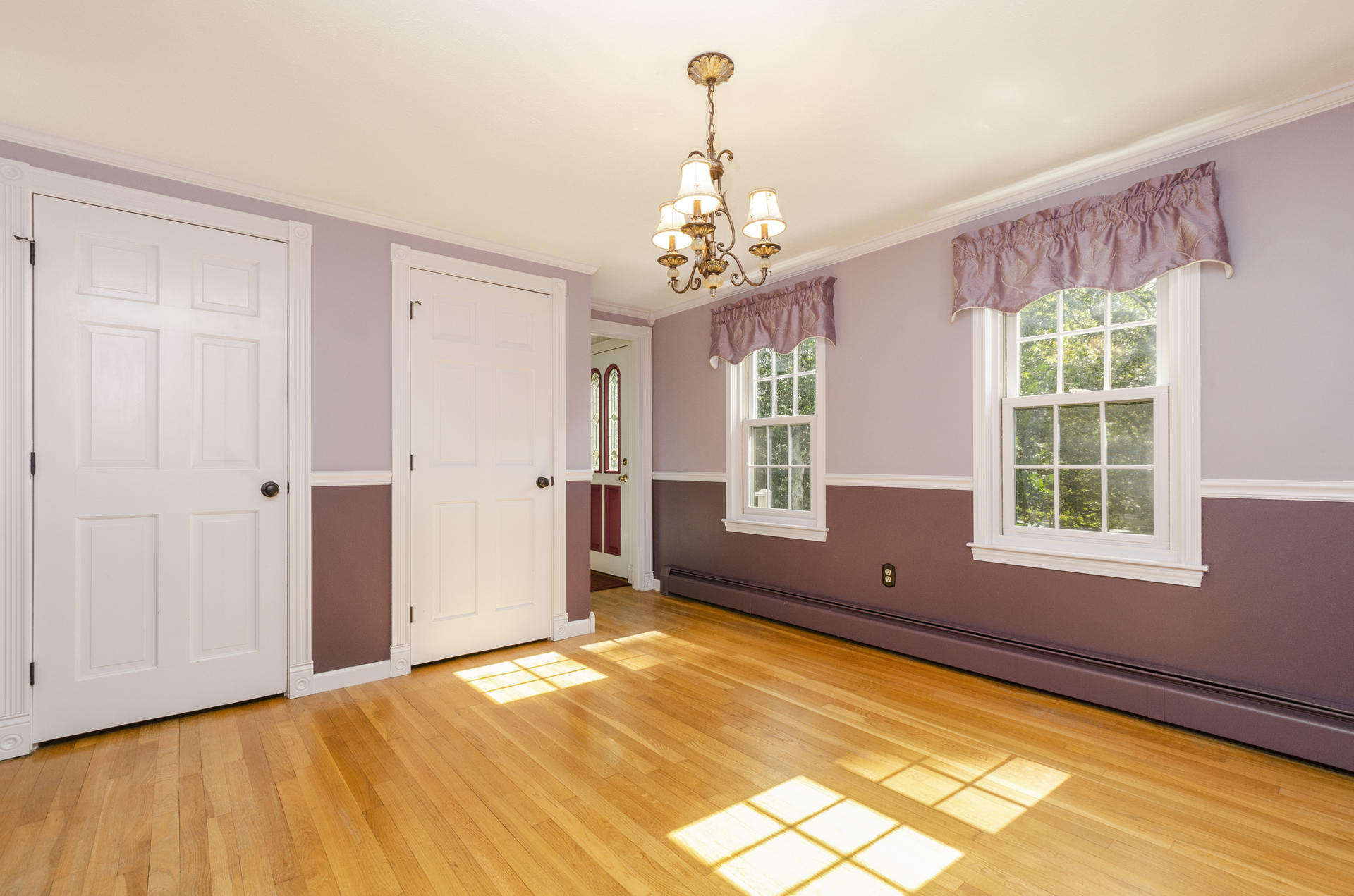 236 Old Mill Road Marstons Mills, MA 02648 - Photo 11 of 20 a view of a livingroom with a chandelier fan and windows