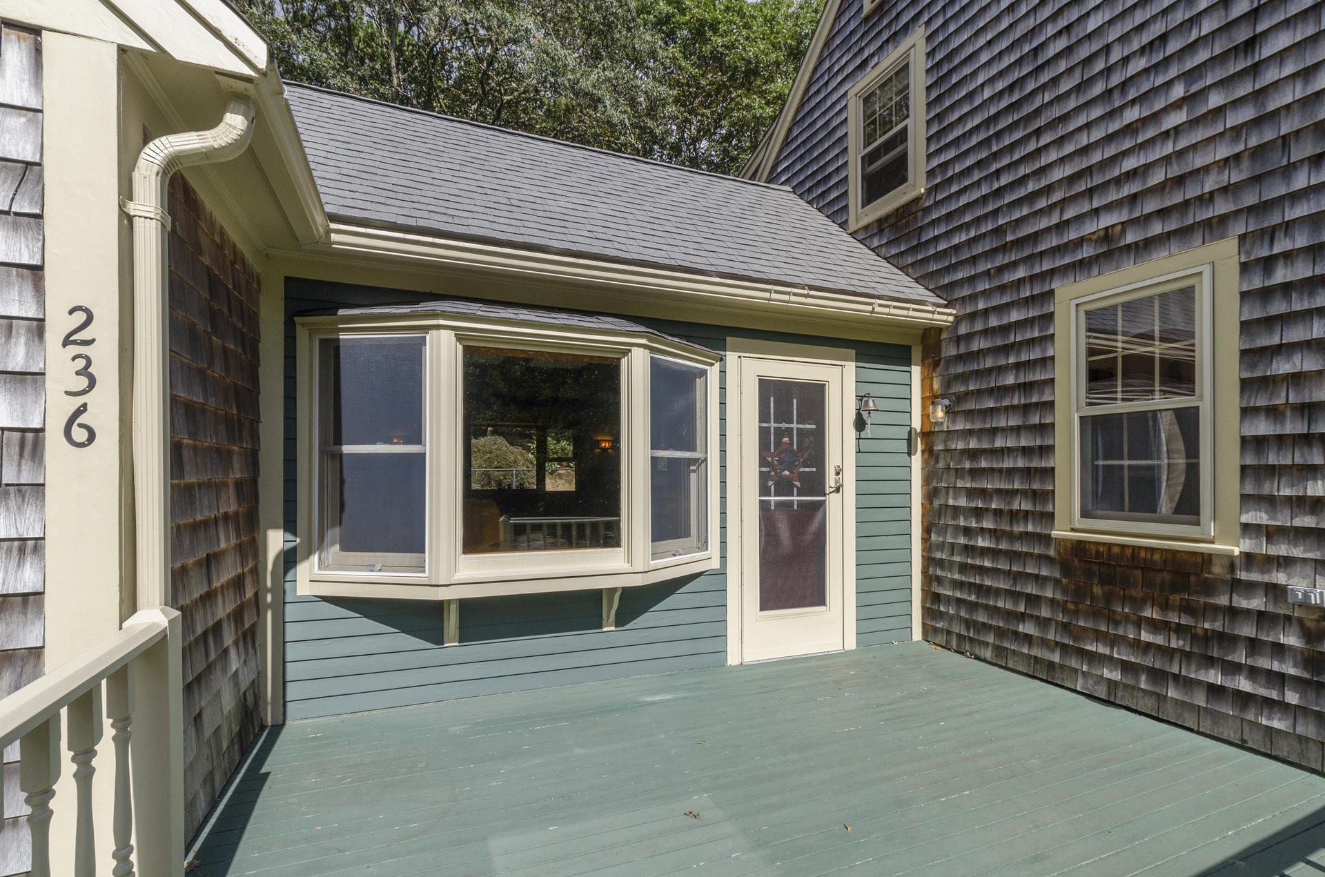 236 Old Mill Road Marstons Mills, MA 02648 - Photo 3 of 20 a view of a brick house with a large window and wooden fence