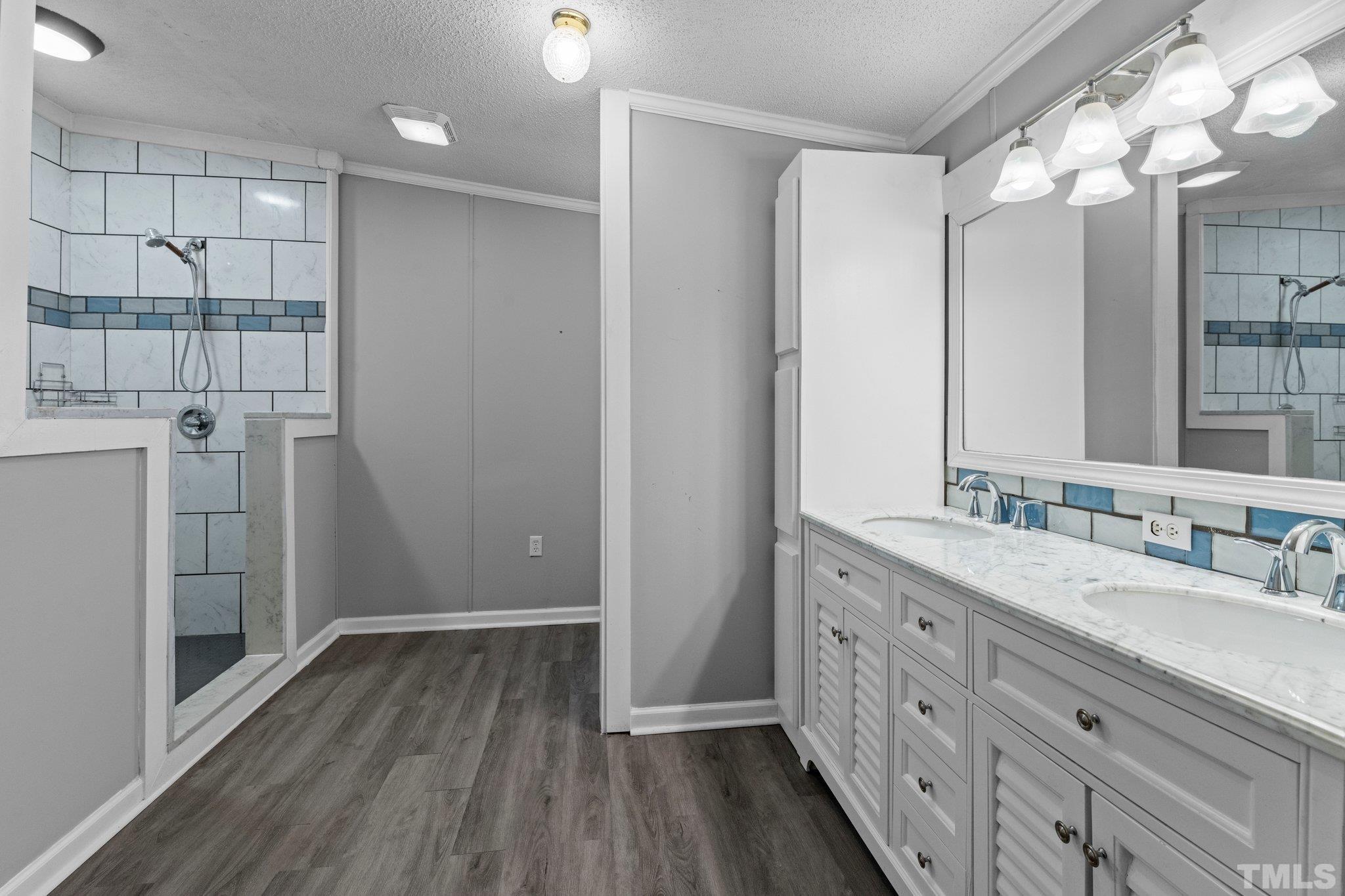 199 New Chestnut Drive Rougemont, NC 27572 - Photo 15 of 28 a bathroom with a double vanity sink and mirror