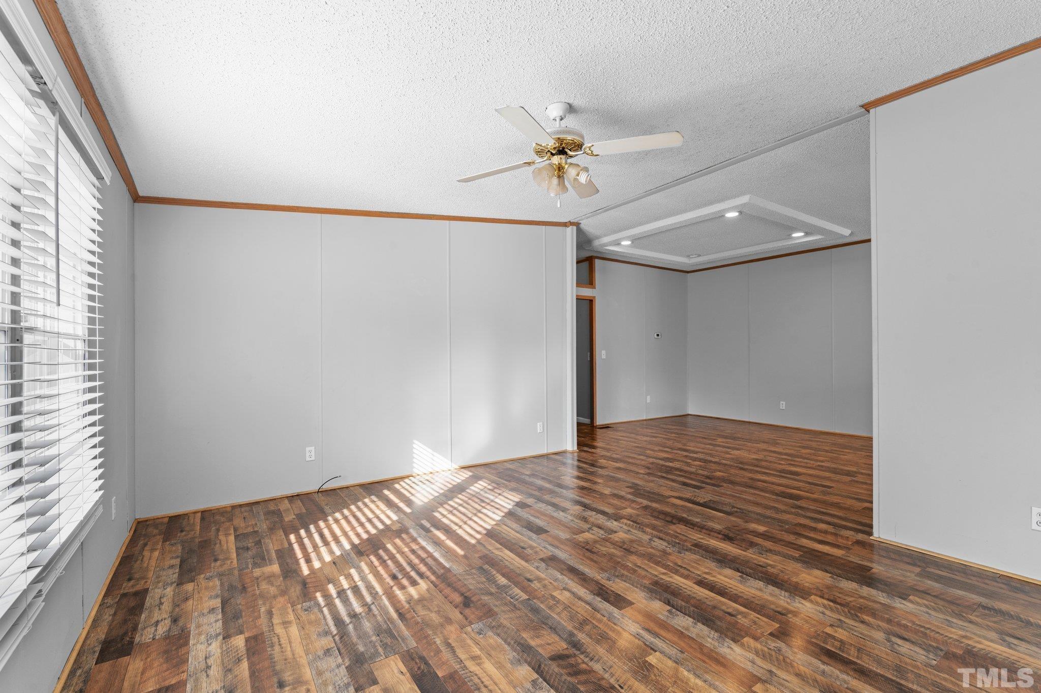 199 New Chestnut Drive Rougemont, NC 27572 - Photo 4 of 28 a view of empty room with wooden floor and fan