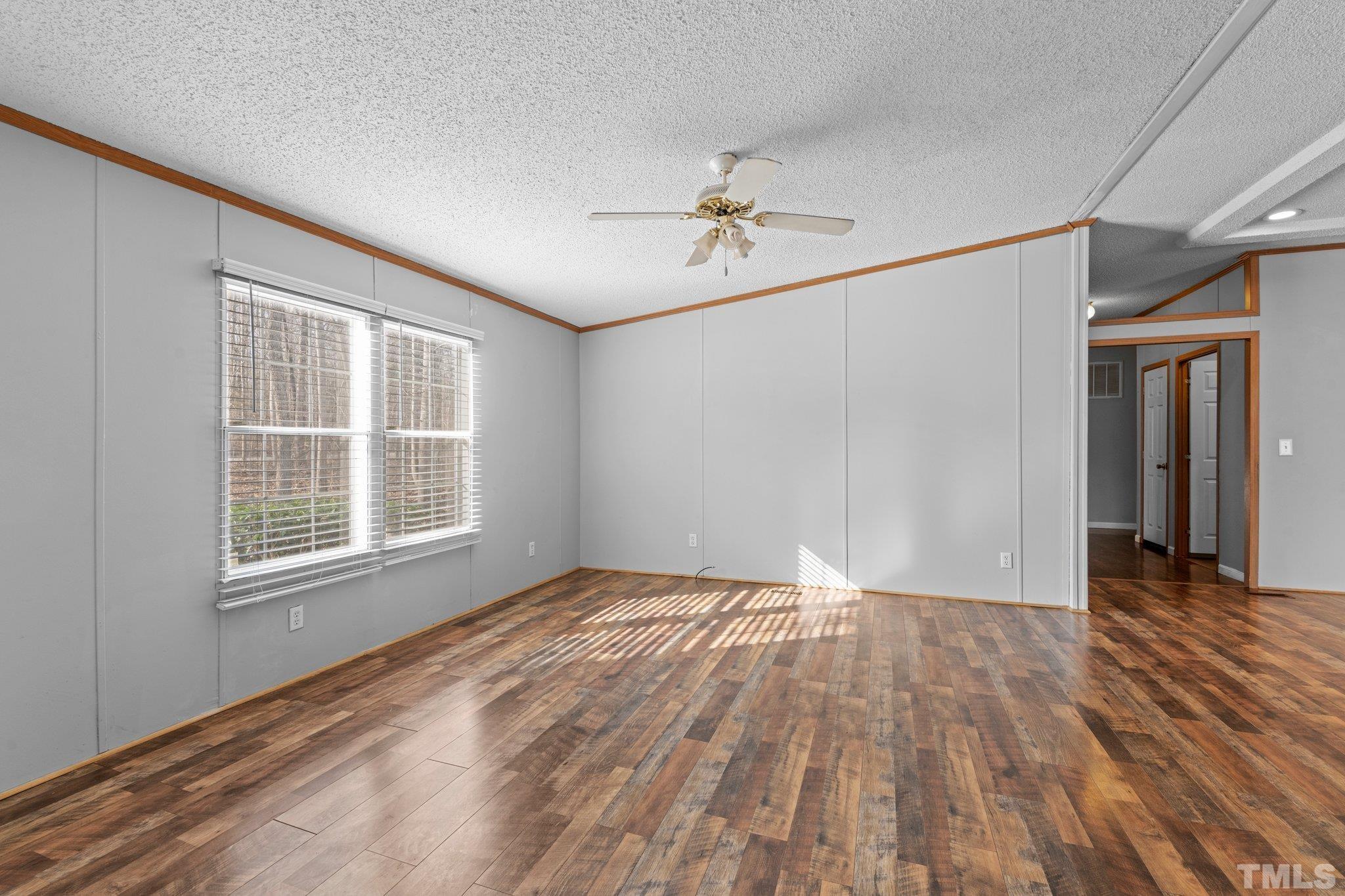 199 New Chestnut Drive Rougemont, NC 27572 - Photo 5 of 28 a view of an empty room with wooden floor and a window