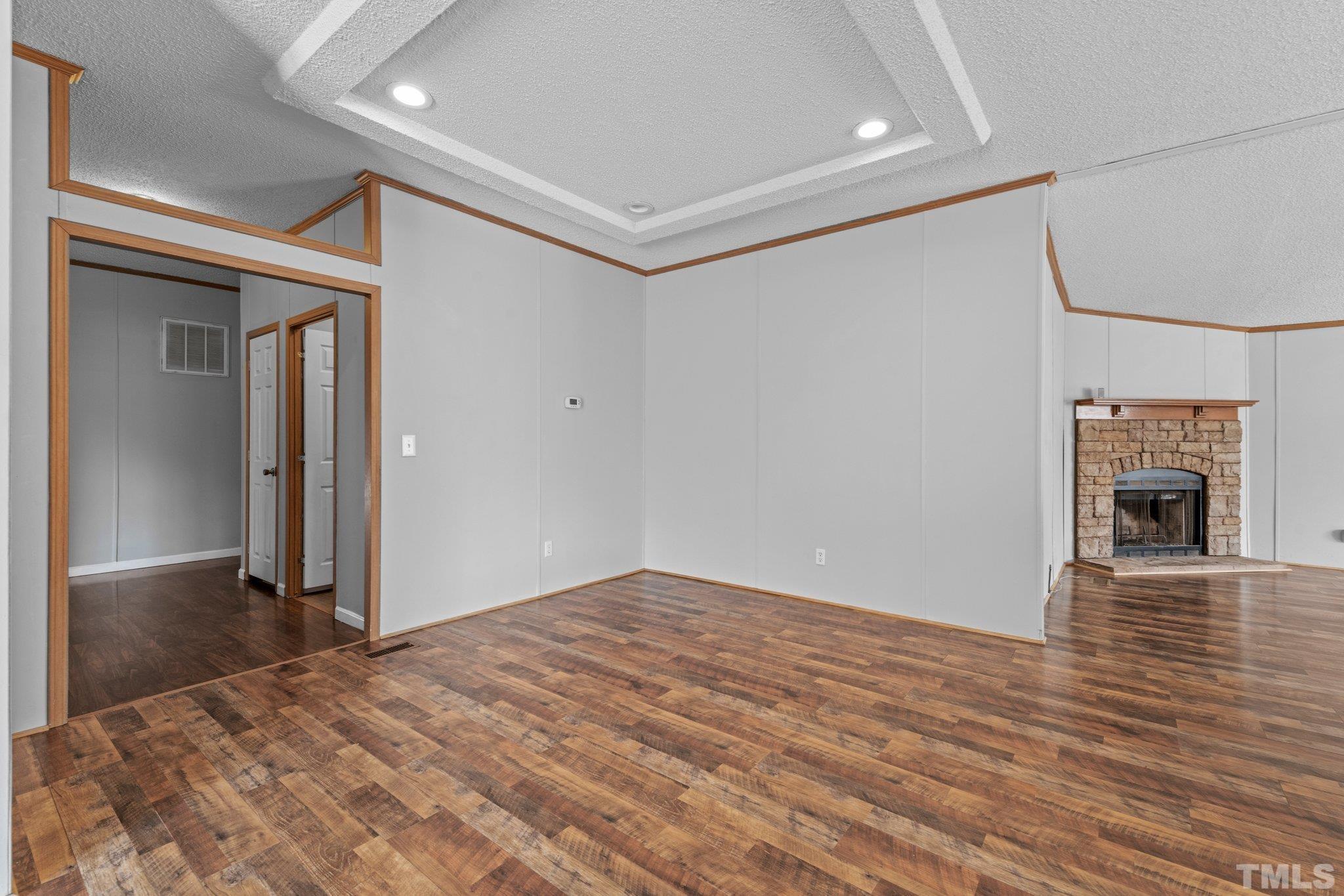 199 New Chestnut Drive Rougemont, NC 27572 - Photo 6 of 28 a view of a livingroom with wooden floor a fireplace