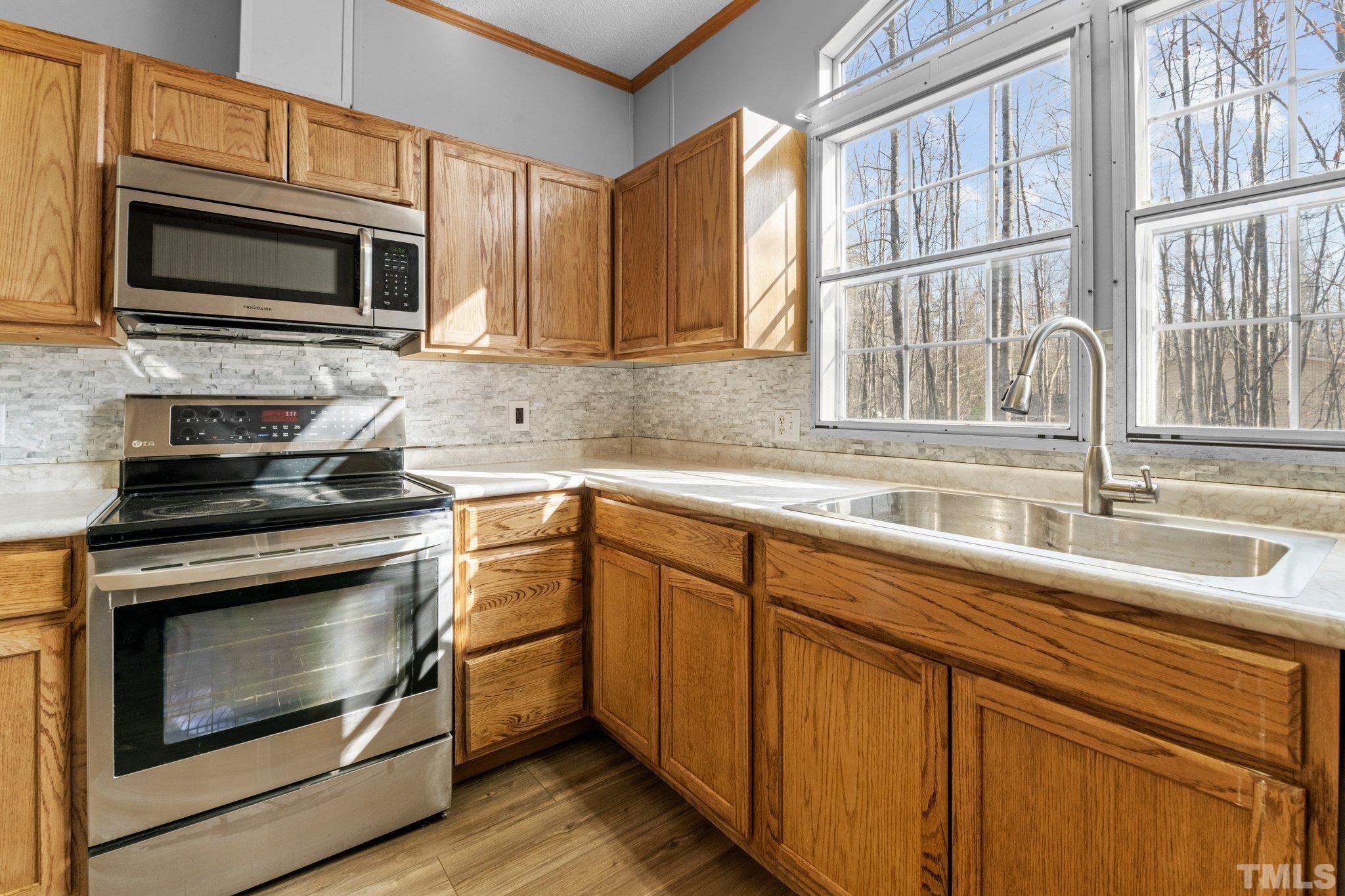 199 New Chestnut Drive Rougemont, NC 27572 - Photo 10 of 28 a kitchen with stainless steel appliances granite countertop a stove microwave and sink